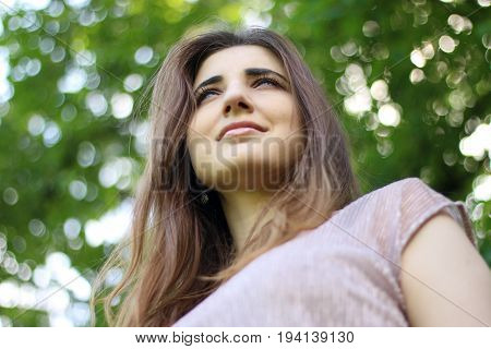 Low angle portrait of a young beautiful woman.