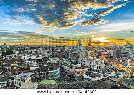 Panorama on skyscraper The top of landmark in Bangkok Trimitr temple is the biggest golden buddha in the world Cityscape is golden light in Twilight The temple at Yaowarat Road Bangkok Thailand.