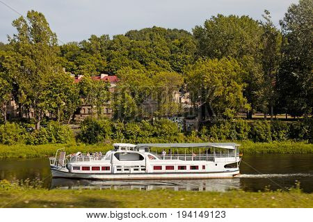 VILNIUS, LITUANIA - JULY 19, 2015: Old Town and the river Neris with ship, Vilnius, Lithuania.