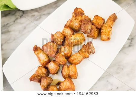 Crispy pork belly on  white plate, Thai food.