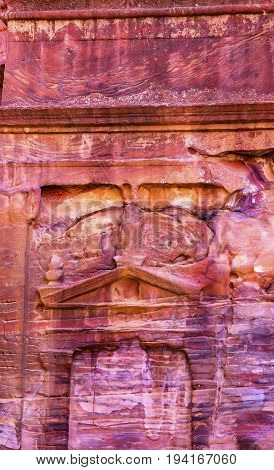 Rose Red Rock Tomb Street of Facades Petra Jordan. Built by the Nabataens in 200 BC to 400 AD. Rose Red canyon walls create many abstracts close up. Inside the Tombs the rose red can become blood red. Reds are created by magnesium in sandstone.