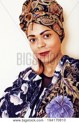 beauty bright african woman with creative make up, shawl on head like cubian closeup smiling, cheerful tan , lifestyle people concept close up