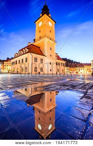 Brasov Transylvania Romania - Twilight image with water reflection of Council House medieval downtown.