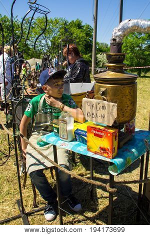Boy Sells Tea From The Old Samovar On Strawberry Festival