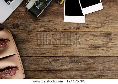 Hipster freelance photographic equipment on a wooden desktop with laptop.