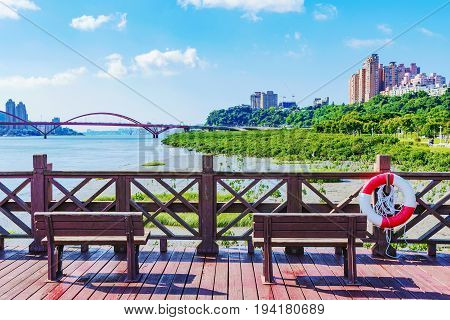 Pier with benches overlooking the riverside area in Taipei