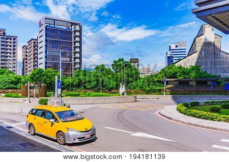 TAIPEI TAIWAN - MAY 29: This is a Taipei taxi waiting outside Guandu mrt station fior a passenger with modern city buildings in the background on May 29 2017 in Taipei
