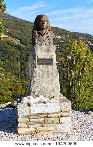 Makrinitsa, Greece - October 11, 2016: Statue of Margaret, Makrinitsa village of Pelion, Greece and sleeping cat