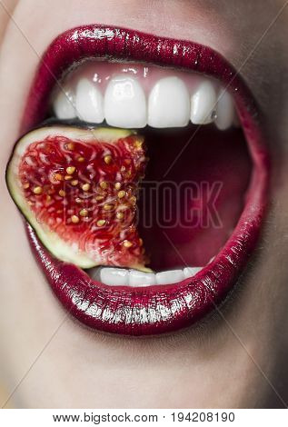 Close-Uo from a Mouth with a fig