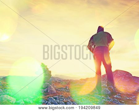 Film Grain Effect.   Tourist Guide At Stocked Stones On Alps Peak. Strong Hiker Enjoy Sunset