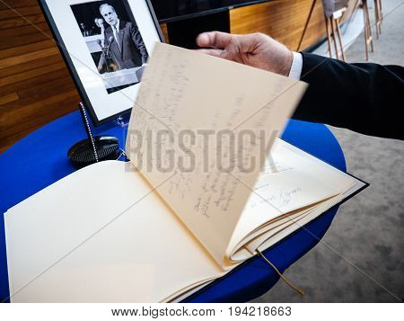STRASBOURG FRANCE - JUL 1 2017: The messages in diverse languages of high ranked officials on the book of condolences next to a portrait of late former German Chancellor Helmut Kohl at European Parliament. Kohl who was Christ democrat or CDU party member