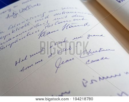 STRASBOURG FRANCE - JUL 1 2017: The messages in diverse languages of high ranked officials on the book of condolences next to a portrait of late former German Chancellor Helmut Kohl at European Parliament. Kohl who was Christ democrat or CDU party member