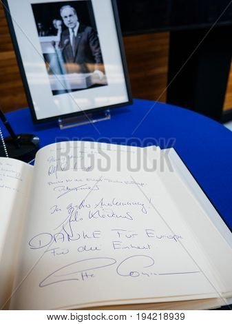 STRASBOURG FRANCE - JUL 1 2017: Danke fur Europe -Thank you for Europe on the book of condolences next to a portrait of late former German Chancellor Helmut Kohl at European Parliament. Kohl who was Christ democrat or CDU party member chancellor of German