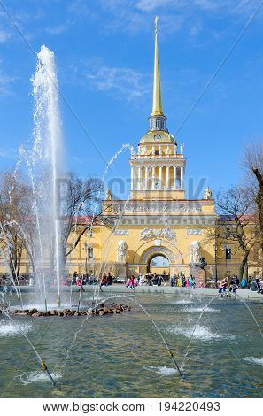 SAINT PETERSBURG RUSSIA - MAY 1 2017: Unknown people are resting by fountain near building of Main Admiralty St. Petersburg Russia