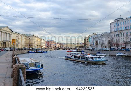 SAINT PETERSBURG RUSSIA - MAY 3 2017: Excursion boats on Fontanka River near Anichkov Bridge St. Petersburg Russia