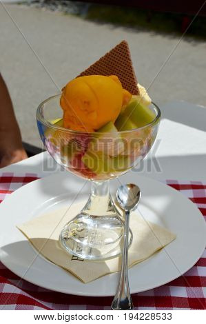 Fresh fruit salad with a bowl of melon ice cream