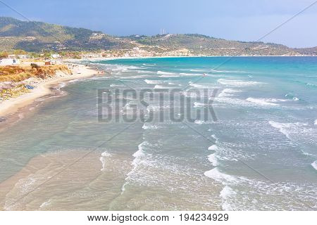 Summer greek beach vacation background with turquoise sea water waves and sandy beach, Sarti, Greece