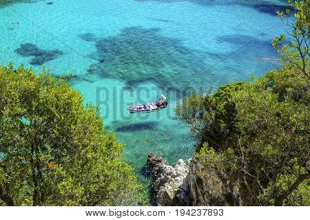 Aerial view on the boat on the crystal sea waer on the beach Paleokastritsa on the Island Corfu Greece.