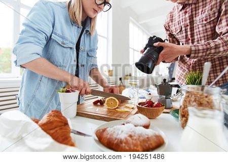 Food-stylist and food-photographer getting ready for shooting food-advert
