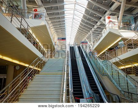 ADLER, RUSSIA, SEP, 07, 2015: Olympic Park railway station interior architecture. Escalators and stairs staircases ways to platforms, metal glass roof. Russian rail roads RZD. Railway station interior