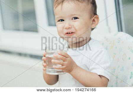 A Boy Drinks Water In The Kitchen