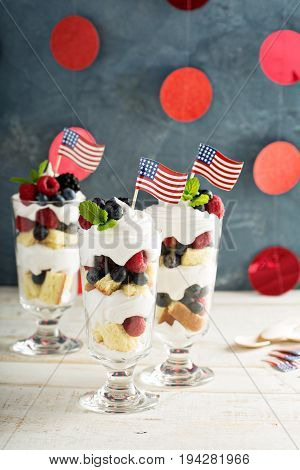 Layered dessert parfait with sweet bread, whipped cream and berries for 4th of July