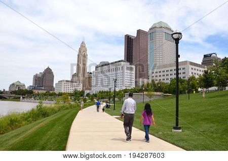 COLUMBUS OH - JUNE 28: Walkers on the Scioto Mile in downtown Columbus Ohio are shown on June 28 2017.