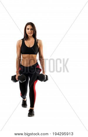 A sporty woman does the lunging of the legs with a dumbbell on her biceps legs in a half-position hands along the torso on a white isolated background