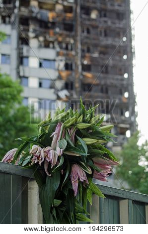A bunch of lilies placed in memory of the 80 feared killed in the Grenfell Tower block fire in Kensington North London.