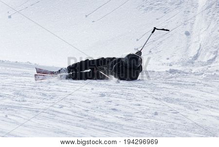The skier fell in the snow at speed .
