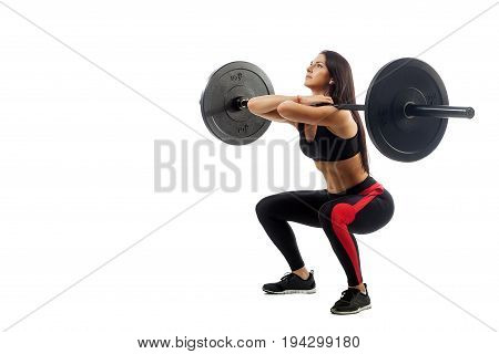 Young athletic brunette woman doing squat with a barbell loki in front of him position full sucker on white isolated background