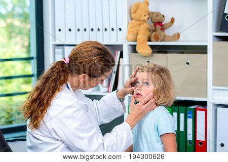 Female Pediatrician In White Lab Coat Examined Little Patient