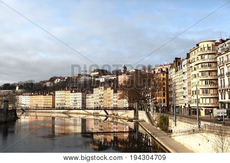 Lyon, France - December 20, 2016: houses on Embankment and bridge St. Vincent. River Saone (Sona) in December 20 2016 in Lyon, France