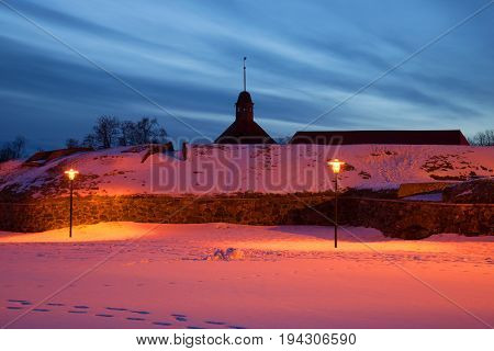 February twilight at the walls of the ancient fortress Korela. Priozersk, Russia