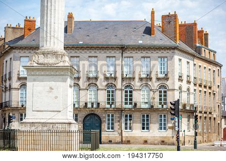 Street view on the Marechal-Foch sqaure with Louis column during the sunny morning in Nantes city in France