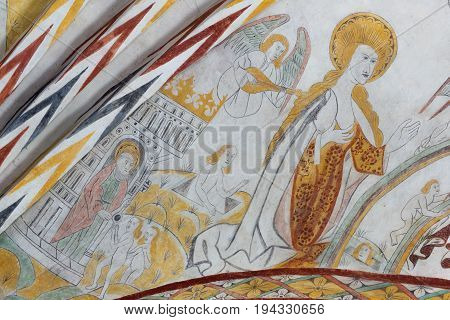 Virgin Mary standing in the kingdom of heaven a gothic fresco in Vinderslev church Denmark June 22 2017