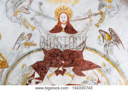 Christ sitting on the rainbow of heaven on judgment day gothic fresco in Vinderslev church Denmark June 22 2017