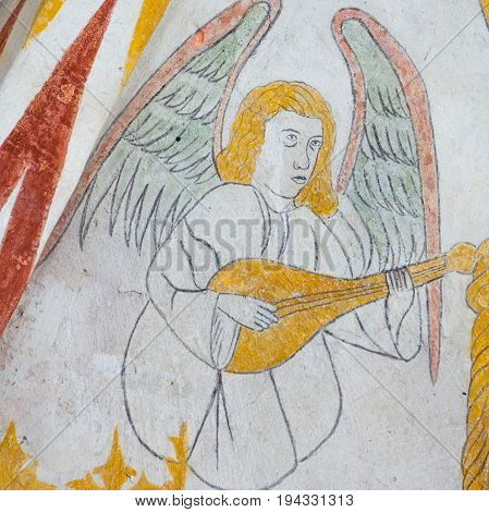 Angel playing the lute medieval gothic fresco in Vinderslev church Denmark June 22 2017