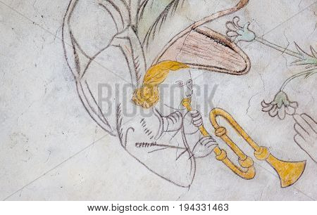 Angel playing the trumpet medieval gothic fresco in Vinderslev church Denmark June 22 2017