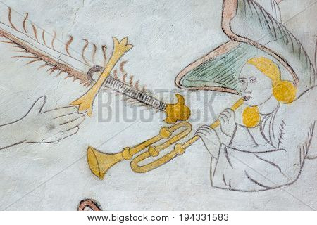 Angel playing the trumpet medieval gothic wall-painting in Vinderslev church Denmark June 22 2017