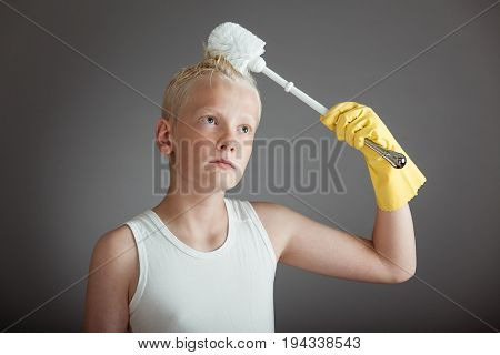 Child Using Toilet Scrubber Brush On His Hair