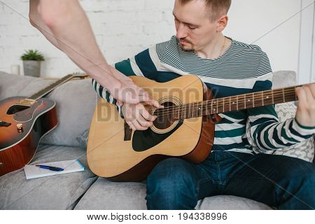 Learning to play the guitar. Music education and extracurricular lessons. Guitarist
