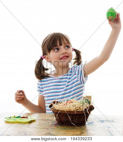 little girl coloring easter eggs - white background