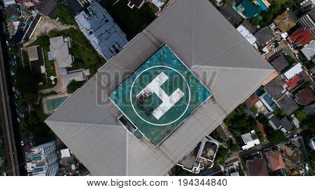 Aerial drone top view of helipad isolated on top of the skycraper in Bangkok city 