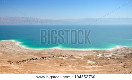 Aerial panoramic landscape of Dead Sea lake with salt water and curative mud shores beaches