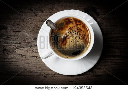 a cup of coffee on old wooden table - breakfast