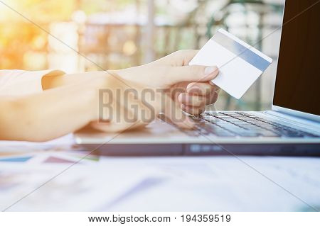 Woman's Hands Holding A Credit Card And Using Smart Phone For Online Shopping.vintage Tone