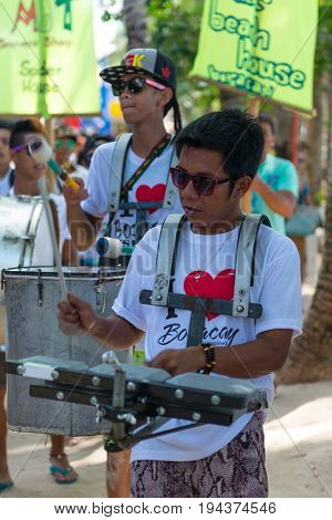 BORACAY, WESTERN VISAYAS, PHILIPPINES - JANUARY 11, 2015: Two men playing music during Ati-Atihan Festival at White Beach.