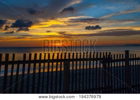 Beautiful Sunset On The Beach. The Silhouette Of The Fence From Boards. Pandan, Panay, Philippines.