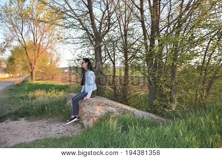 Sit woman are waiting in the forest